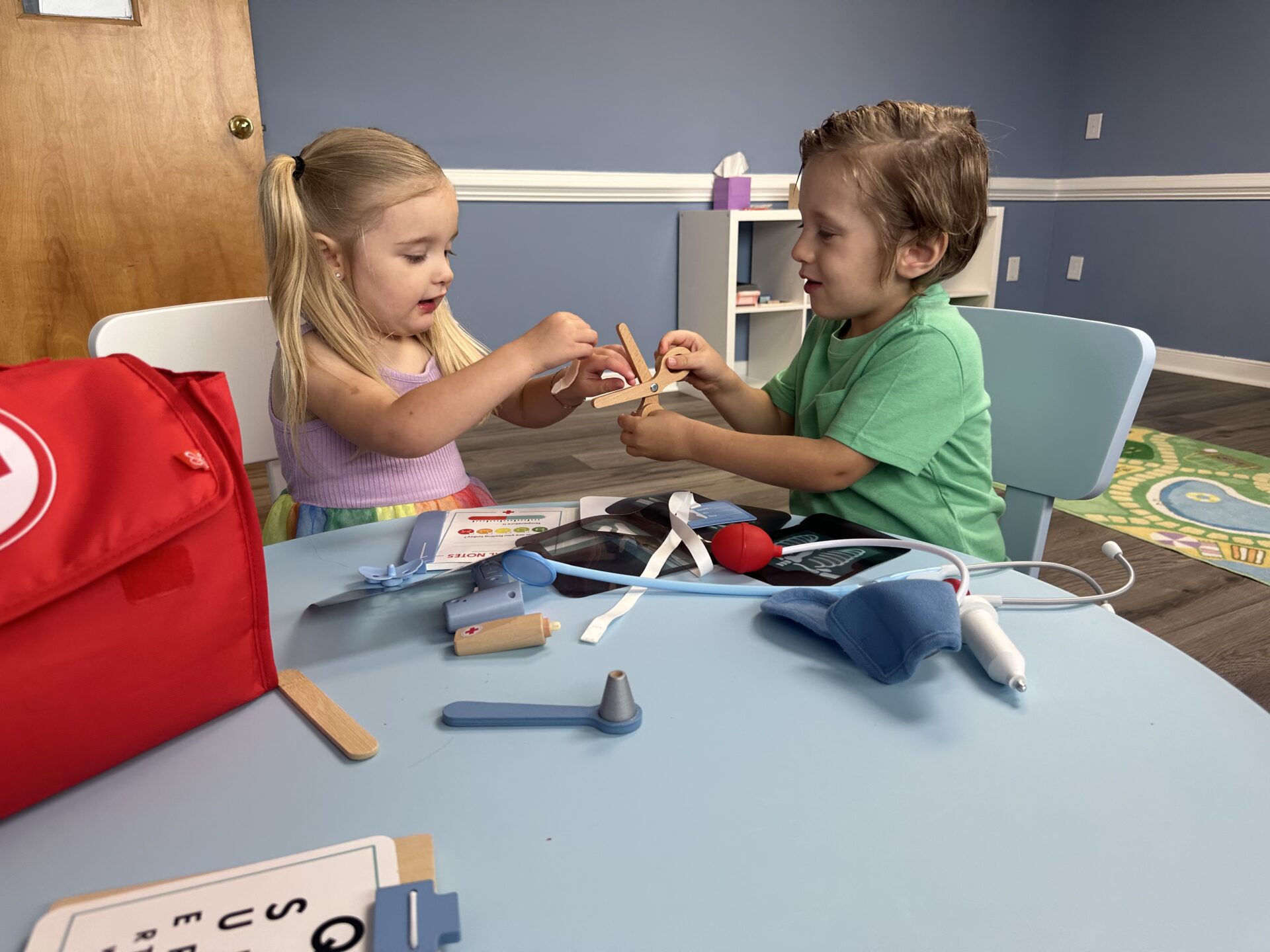 Two children playing at table during ABA therapy services